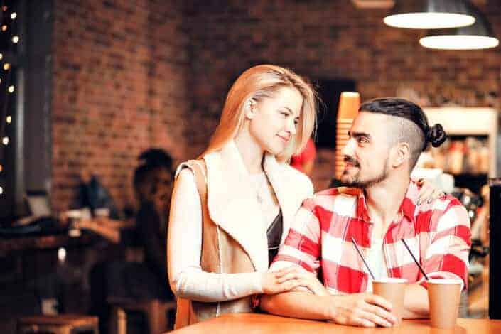Man and woman flirt and drink coffee shop