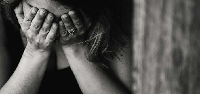 Woman Covering Her Face With Her Hands
