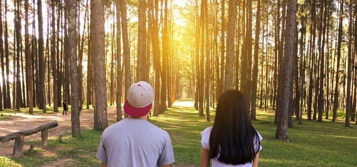 Man and Woman Looking Out Into the Woods