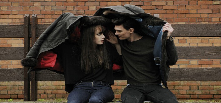 Man sharing his jacket to his woman