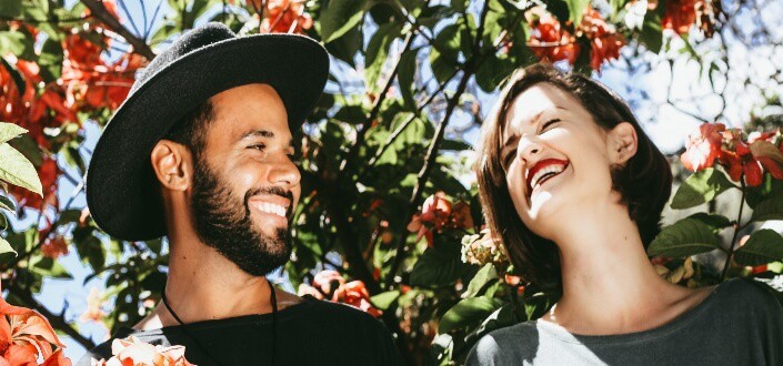 couple laughing happily under the sun