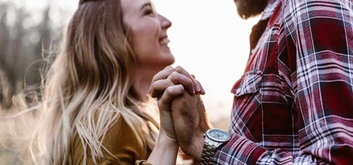 couple holding hands facing each other
