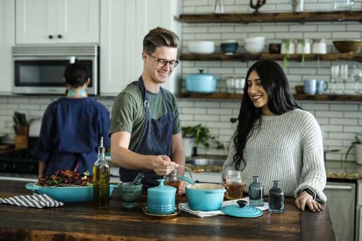 man and woman cooking in a kitchen