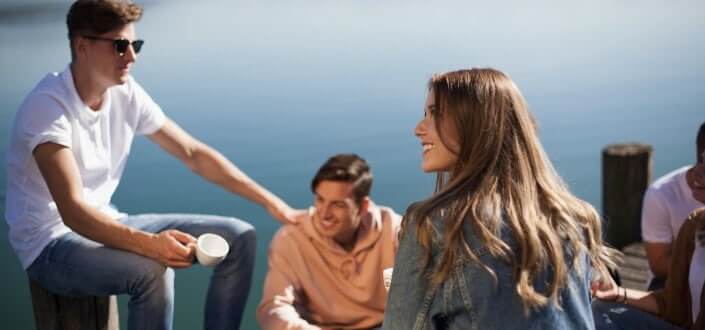 friends having fun near body of water