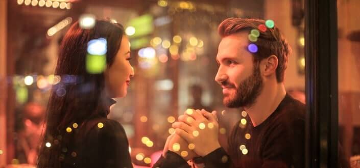 Serious man holding her girlfriend's hands