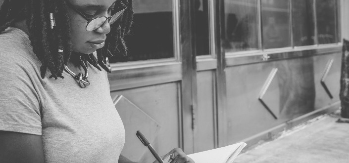 Girl writing down on a notebook