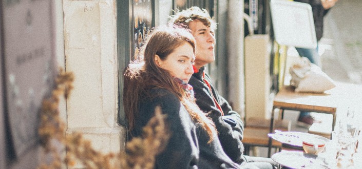 Couple leaning against a wall