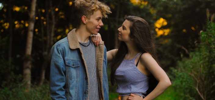 Couple looking at each other in forest