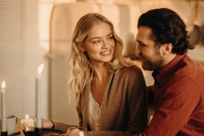 Couple having romantic dinner with candles - random questions to ask a guy 