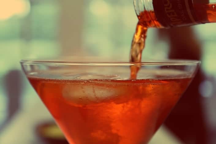 Pouring alcohol into a margarita glass