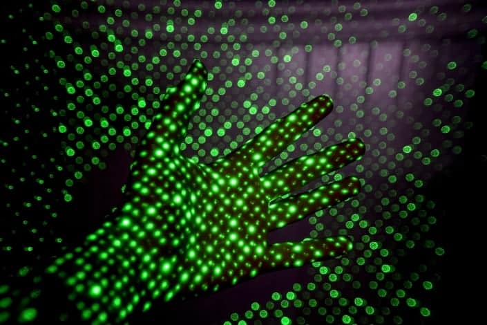 Hand with holographic green lights reflections