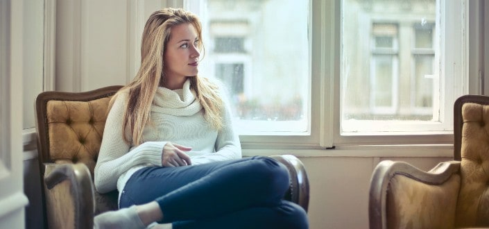 woman sitting on couch comfortably