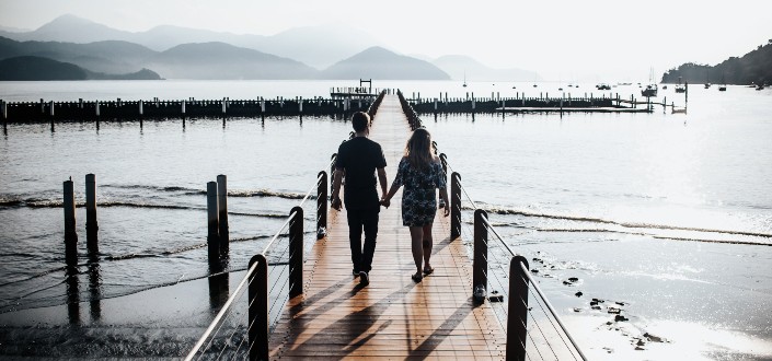 couple on walkway by the sea