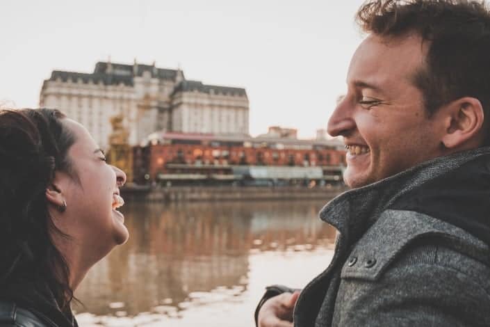 couple laughing together by the river