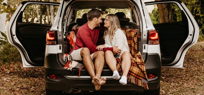 Couple Having a Cozy Afternoon at the Trunk of a Car