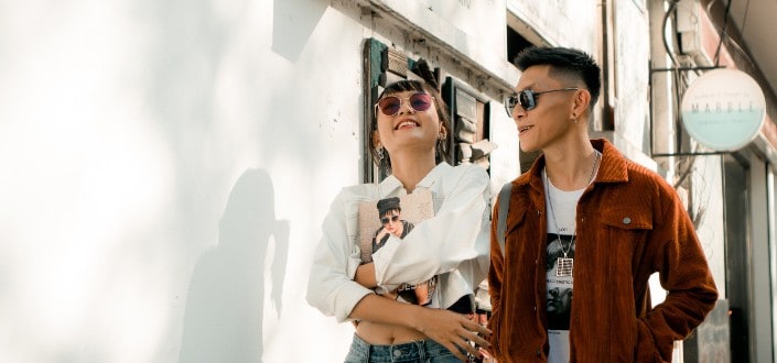 Couple Walking on a Road And Smiling