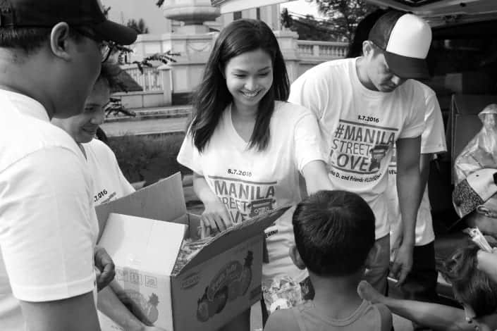 Girl Smiling as She Does Volunteer Work With Kids