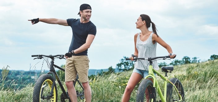 Couple biking on a trail.