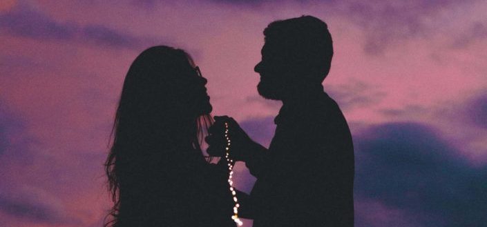 man and woman dancing in the dark