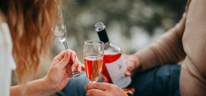 Persons Holding Glass Flutes While Drinking