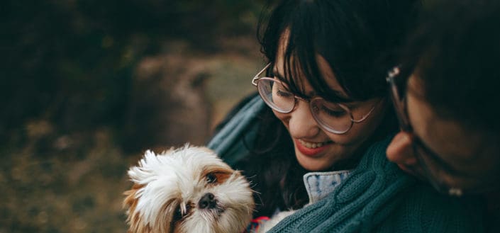 Puppy Carrying by Smiling Woman