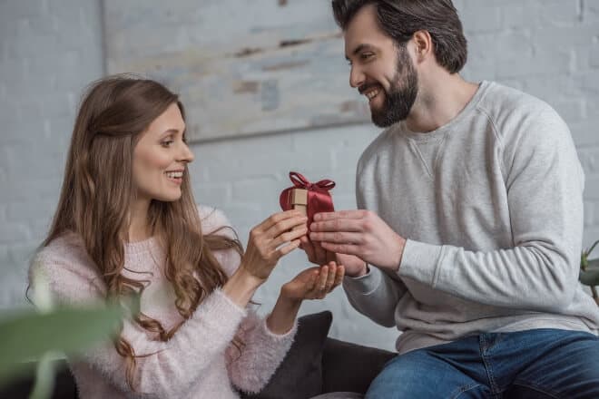 valentine's day gifts for boyfriend - man giving small gift to his girl