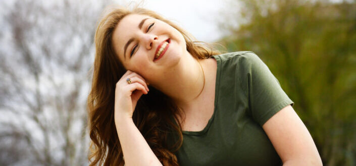 cheerful woman with her eyes closed