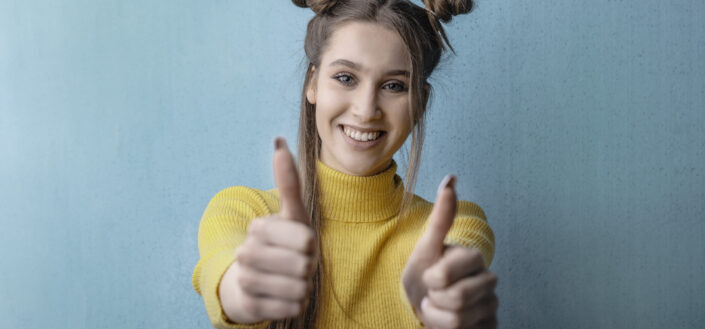 Young woman showing thumbs up