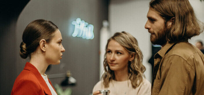 Two women and a man talking