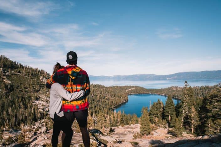 Couple hugging each other beside beautiful view