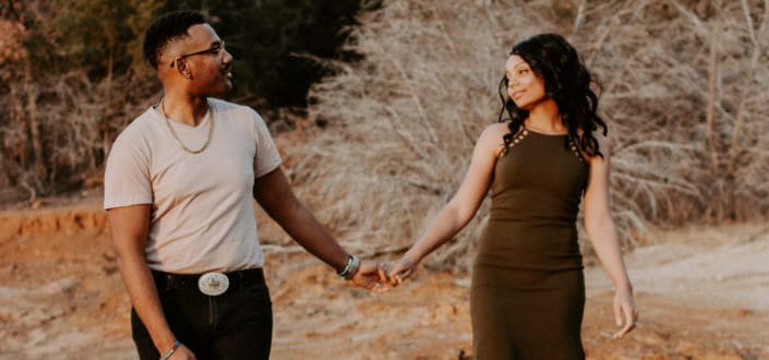 young couple holding hands together