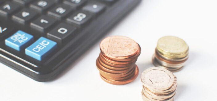 stacks of coins and calculator