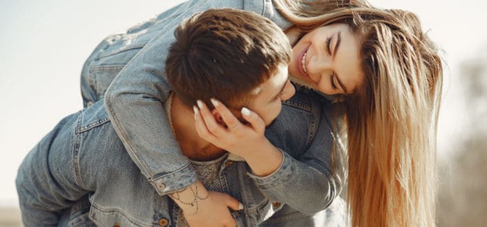 man giving his girl a piggyback ride