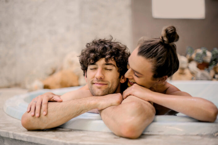 Couple getting intimate in the jacuzzi.