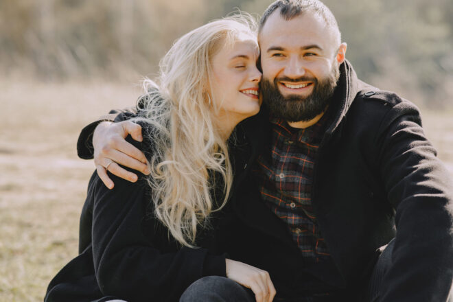 man and woman hugging outdoors - anniversary gifts for husband