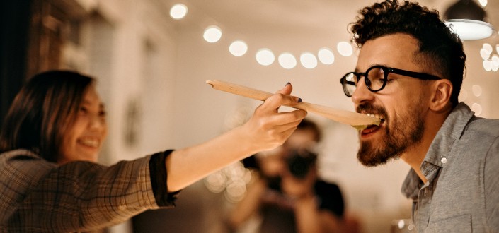 Woman Holding Ladle Beside Man