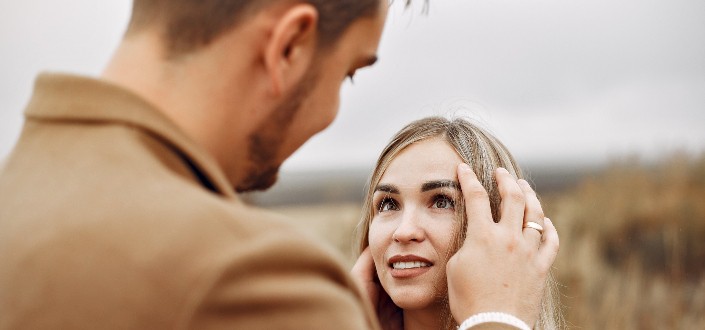young couple looking at each other in countryside