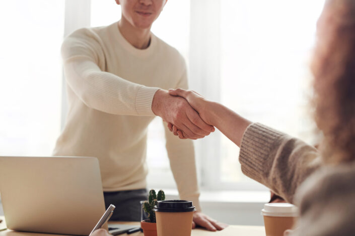 Man and a woman shaking hands.