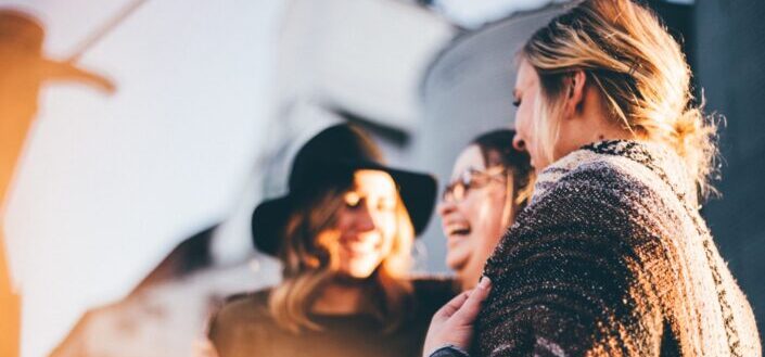 Three girls laughing hard.