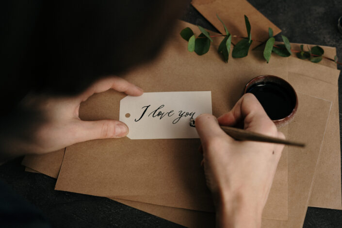 "I love you" being written in calligraphy.