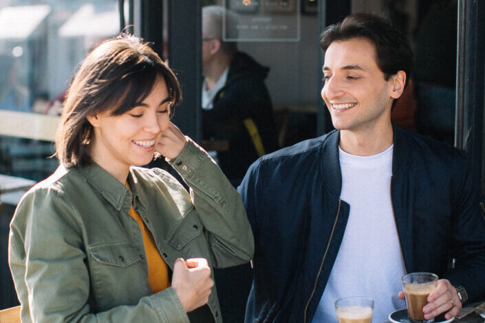 Guy affectionately staring at his amused girl.