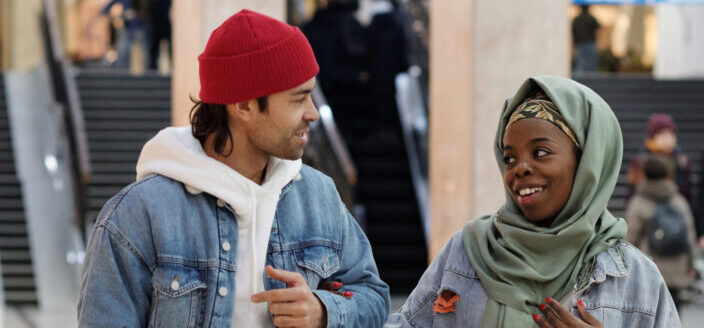 Couple, sweet-talking while walking.