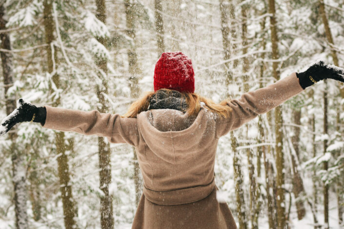 Girl, enjoying the snow in the forest.