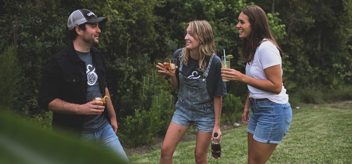 Friends chatting in a refreshing backyard.