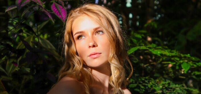 A pretty woman enjoying the sun rays on her face
