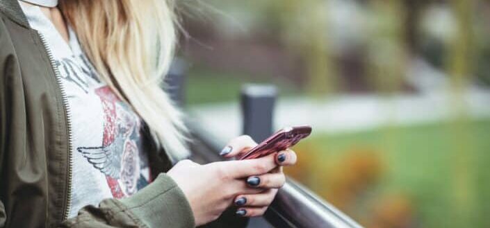 Girl, browsing through her phone.