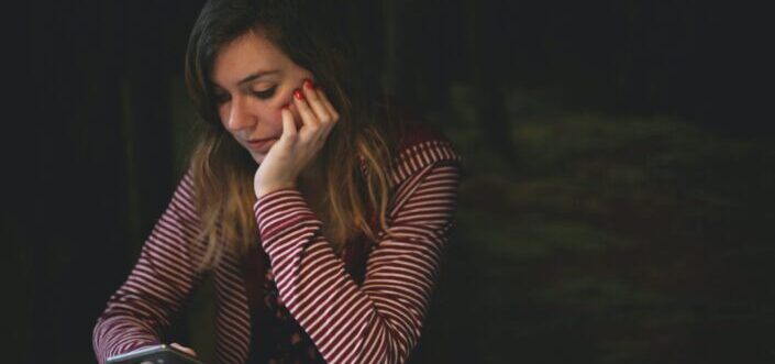 woman using phone at the table
