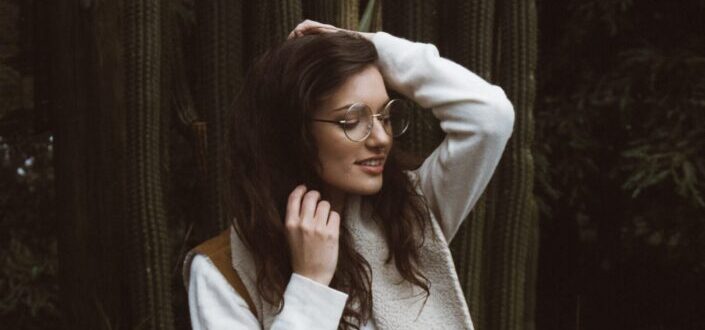 Girl wearing glasses, self-reflecting.