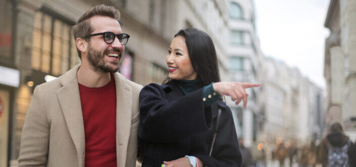 Woman pointing at something with his man