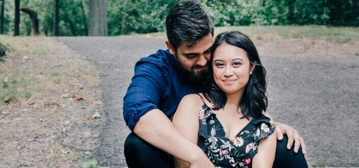 Sweet couple sitting along an empty road